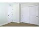 Bedroom view of new wood floors, white trim, a door, and a closet with sliding doors at 4019 W Lemon St, Tampa, FL 33609