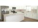 Bright kitchen featuring stainless steel appliances, an island, and shaker style cabinets at 4019 W Lemon St, Tampa, FL 33609