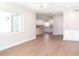 Bright living room with light hardwood floors flowing into a modern white kitchen at 4019 W Lemon St, Tampa, FL 33609