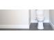 Compact powder room featuring a modern toilet and sleek gray tiled floors at 4019 W Lemon St, Tampa, FL 33609