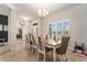 Elegant dining room featuring a chandelier, plantation shutters, and a view of the house's front entrance at 41043 Stanton Hall Dr, Dade City, FL 33525