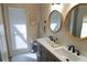 Bright and airy bathroom with double sinks, modern fixtures, and a clean, contemporary design at 4108 Daisy Dr, Hernando Beach, FL 34607