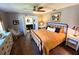 Bedroom with ceiling fan, wood floors, neutral decor, and adjoining bathroom at 4108 Daisy Dr, Hernando Beach, FL 34607