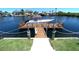 Dock with boat parked featuring boat lift and waterfront access with seawall at 4108 Daisy Dr, Hernando Beach, FL 34607