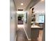 Hallway view leading into the kitchen showcasing the wood floors and open concept design of the home at 4108 Daisy Dr, Hernando Beach, FL 34607