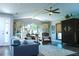 Bright living room with vaulted ceilings, large windows, and stylish furnishings, creating a cozy atmosphere at 4108 Daisy Dr, Hernando Beach, FL 34607