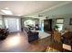 Open concept living room area with a ceiling fan, hardwood floors, and fireplace at 4108 Daisy Dr, Hernando Beach, FL 34607
