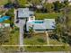 Aerial view of home with a detached garage, pool, a brick driveway, and lush landscaping at 524 Park S St, St Petersburg, FL 33707