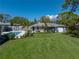 This backyard features a pool, patio furniture, a well-manicured lawn and lush landscaping at 524 Park S St, St Petersburg, FL 33707