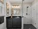 Bathroom featuring a glass shower, black granite counters, and modern lighting at 524 Park S St, St Petersburg, FL 33707