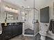 Gorgeous bathroom featuring a glass shower and a dark vanity with a black countertop at 524 Park S St, St Petersburg, FL 33707