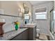 Stylish bathroom with a sleek vanity, square sink, modern fixtures, and elegant marble-style tile at 524 Park S St, St Petersburg, FL 33707