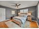 Charming bedroom featuring wood floors, a ceiling fan, white shutters, and a cozy rug at 524 Park S St, St Petersburg, FL 33707