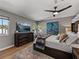 Beautiful bedroom featuring a king-sized bed, gray walls, a ceiling fan, and a large TV at 524 Park S St, St Petersburg, FL 33707