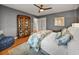 Bedroom features hardwood floors, a ceiling fan, and a display cabinet at 524 Park S St, St Petersburg, FL 33707