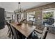 Charming dining room boasting brick accents, modern chandelier, and natural light with a pool view from windows at 524 Park S St, St Petersburg, FL 33707