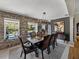 Dining room with exposed brick, modern chandelier, and a view of the outdoor pool at 524 Park S St, St Petersburg, FL 33707