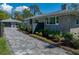 Charming stone home with a brick driveway, complemented by beautifully landscaped gardens at 524 Park S St, St Petersburg, FL 33707