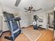 Spacious home gym with a treadmill, elliptical machine, and access to a full bathroom at 524 Park S St, St Petersburg, FL 33707