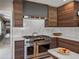Stainless steel range hood and oven provide a gourmet cooking experience in this beautifully designed kitchen at 524 Park S St, St Petersburg, FL 33707