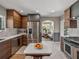 Bright kitchen offers stainless steel appliances, custom cabinets, and an island with stone countertop at 524 Park S St, St Petersburg, FL 33707