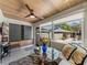 Bright living room with wood ceiling, statement table, and view of outdoor pool area at 524 Park S St, St Petersburg, FL 33707