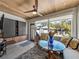 Bright sunroom featuring stylish furniture, a decorative giraffe, and views of the serene backyard at 524 Park S St, St Petersburg, FL 33707