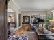 Spacious living room with a leather couch, hardwood floors, artwork, and abundant natural light at 524 Park S St, St Petersburg, FL 33707