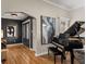 Sophisticated living room featuring hardwood floors, a grand piano, and elegant artwork on the walls at 524 Park S St, St Petersburg, FL 33707