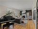 Elegant living room featuring a fireplace, piano, hardwood floors, and ample natural light at 524 Park S St, St Petersburg, FL 33707