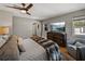 Comfortable main bedroom features hardwood floors, a ceiling fan, and a mounted TV for ultimate relaxation at 524 Park S St, St Petersburg, FL 33707