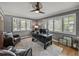 Inviting home office space with dark desk, ceiling fan, plush rug, and ample natural light at 524 Park S St, St Petersburg, FL 33707