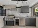 Outdoor kitchen with a grill, sink, and stainless steel appliances at 524 Park S St, St Petersburg, FL 33707