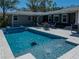 Inviting in-ground pool and spa with patio furniture, perfect for outdoor relaxation and entertaining at 524 Park S St, St Petersburg, FL 33707