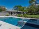 Sparkling in-ground pool and hot tub with stylish patio furniture and well-manicured landscaping at 524 Park S St, St Petersburg, FL 33707