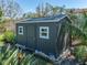 Backyard shot of the shed, featuring plants in the front and palm trees on the side at 524 Park S St, St Petersburg, FL 33707