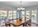 Dining room with waterfront views, a large table, and sliding doors to an outdoor seating area at 5405 Aloha Dr, St Pete Beach, FL 33706