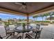 Inviting outdoor dining area with a table and chairs overlooking the pool and waterfront at 5405 Aloha Dr, St Pete Beach, FL 33706