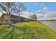 A view of a house and backyard with a screened in porch which overlooks a canal at 5638 Sunset Falls Dr, Apollo Beach, FL 33572