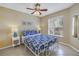 Cozy bedroom with tile flooring, a comfortable bed with blue patterned linens, side tables and a window at 6181 Bahia Del Mar Blvd # 112, St Petersburg, FL 33715