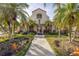Inviting community clubhouse surrounded by lush landscaping and swaying palm trees at 6181 Bahia Del Mar Blvd # 112, St Petersburg, FL 33715
