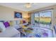 Cozy living room featuring stylish decor, comfortable seating, and sliding glass doors with golf course views at 6181 Bahia Del Mar Blvd # 112, St Petersburg, FL 33715