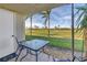 A cozy patio features a table and chairs with a view of the perfectly manicured golf course at 6181 Bahia Del Mar Blvd # 112, St Petersburg, FL 33715