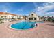 Community pool area with beach chairs and views of the building and landscaping at 6181 Bahia Del Mar Blvd # 112, St Petersburg, FL 33715