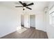 Clean, minimalist bedroom featuring vinyl floors, a ceiling fan, and a closet at 679 71St N Ave, St Petersburg, FL 33702