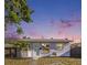 Charming single-story home featuring a freshly painted exterior, well-maintained lawn, and inviting front entrance with a light blue door at 679 71St N Ave, St Petersburg, FL 33702