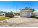 Detached single-car garage featuring a carport and a paved driveway at 679 71St N Ave, St Petersburg, FL 33702