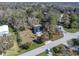 An aerial view of a home with an expansive lot surrounded by mature trees and lush landscaping at 6841 Collingswood Ct, New Port Richey, FL 34655