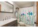 Neat bathroom featuring a modern vanity, mirror, and a charming shower curtain with colorful sea life designs at 6905 El Camino Paloma St, Port Richey, FL 34668