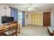 Comfortable bedroom with a desk area, blue patterned curtains, and closet space at 6905 El Camino Paloma St, Port Richey, FL 34668